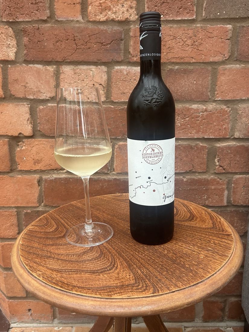 White wine and bottle against a brick wall