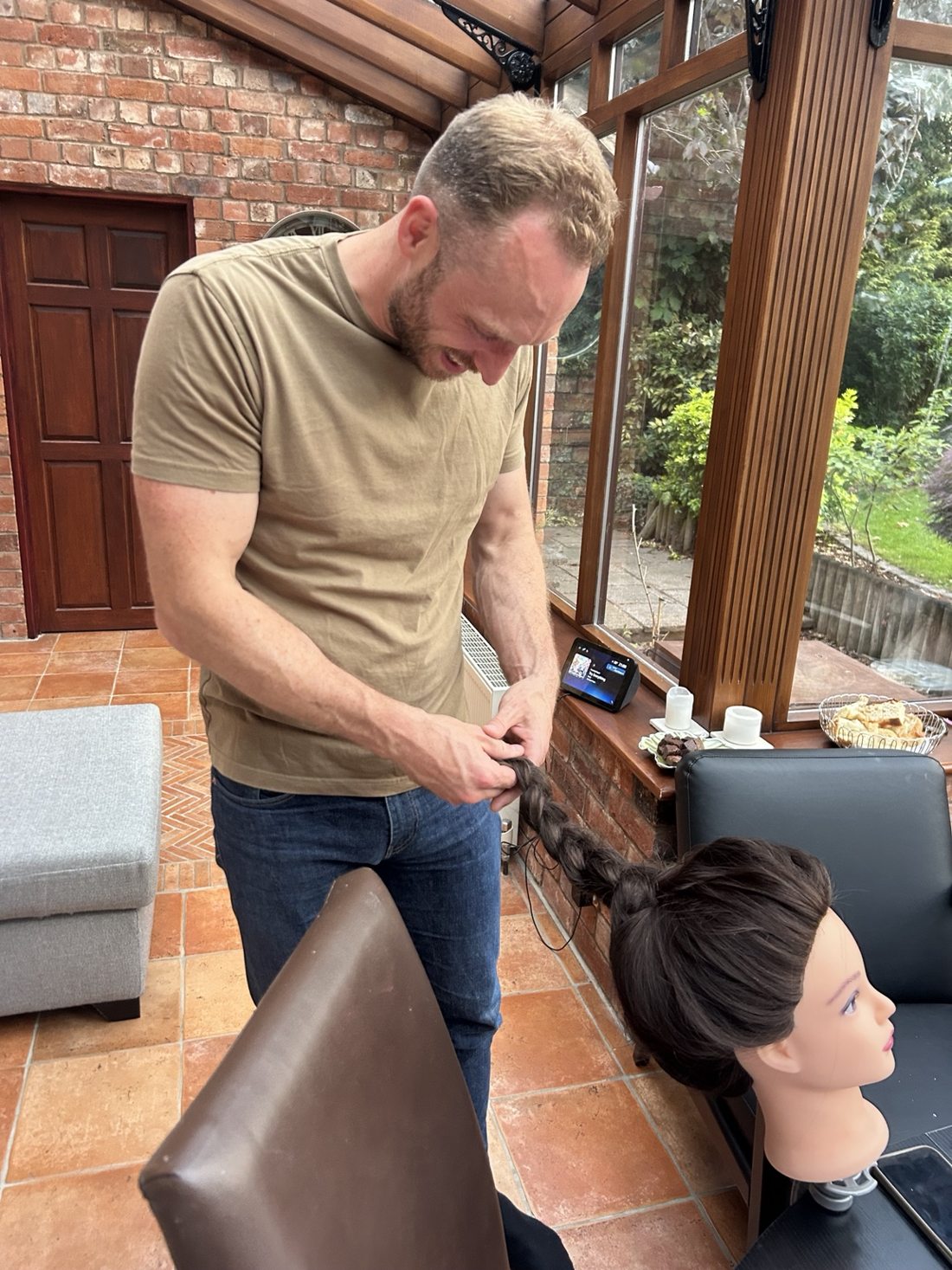 A guest practising hair braiding